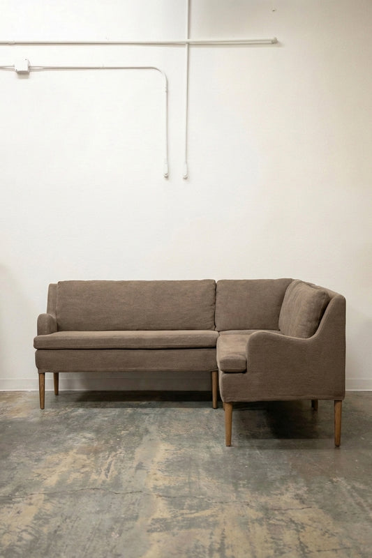 Mid-century modern L-shaped sectional sofa in taupe boucle fabric with tapered oak legs