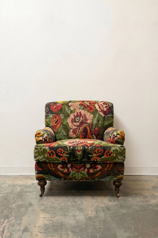 Victorian armchair in bold multicolor floral tapestry with turned legs and brass casters